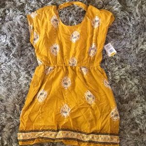 Yellow open back mini dress.